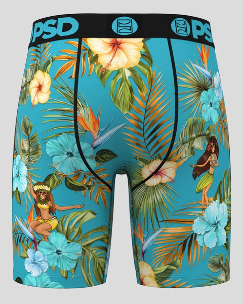 Turquoise boxer briefs with tropical floral print, palm fronds, hibiscus flowers, and hula dancers on blue background.