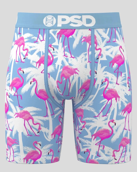 PSD boxer briefs with blue waistband featuring magenta flamingos and white palm fronds on light blue background.