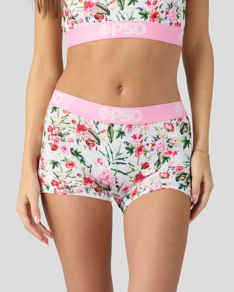 Woman wearing floral print bra and boyshort underwear with pink elastic waistband.