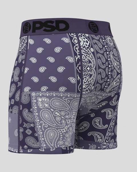 Dusk purple bandana-print shorts with PSD waistband and mixed paisley and geometric white patterns throughout.