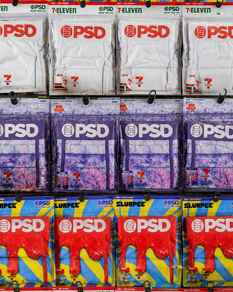 7-Eleven Big Gulp Grape beverage packages displayed on retail shelf with white, purple, and red packaging.