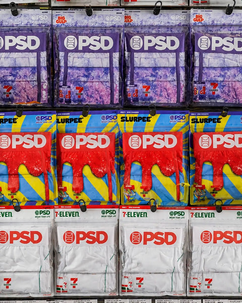 PSD clothing packages displayed on retail shelf with purple, red, and white designs featuring Slurpee branding.