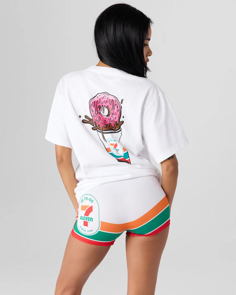 White t-shirt with pink frosted donut graphic and 7-Eleven cup design on back.