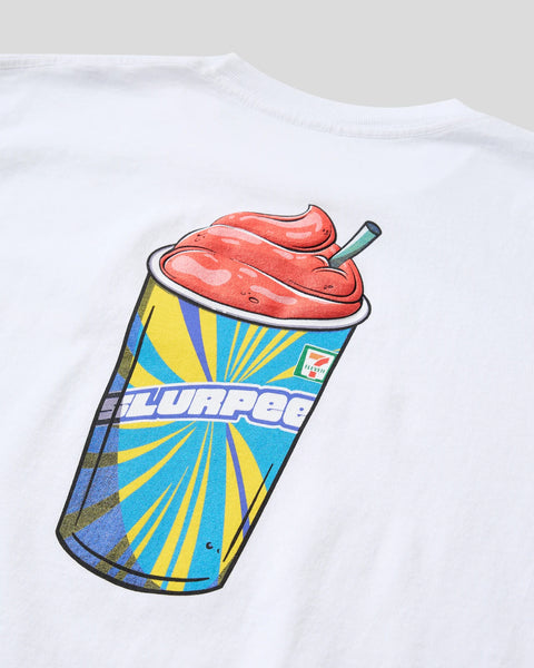 White t-shirt with colorful Slurpee cup graphic featuring red frozen drink and straw on chest.