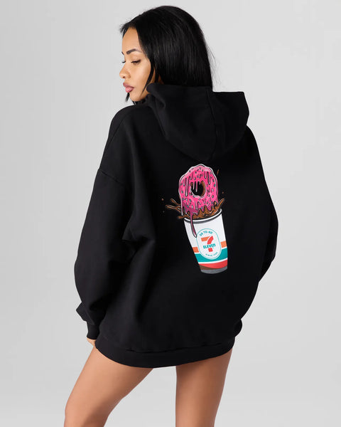 Black pullover hoodie with pink frosted donut and 7-Eleven cup graphic on back.