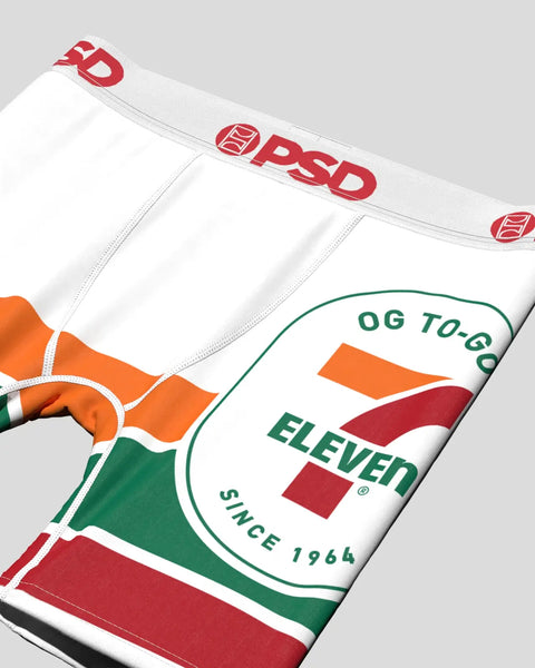 White to-go cup with 7-Eleven branding in red and green, featuring orange and red stripe design on lower portion.