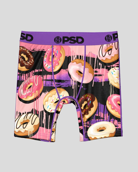 Men's boxer briefs with purple waistband featuring colorful donut print and dripping icing design on pink and black backgroun